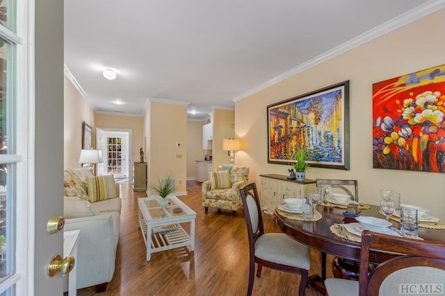 dining room featuring crown molding and hardwood / wood-style flooring