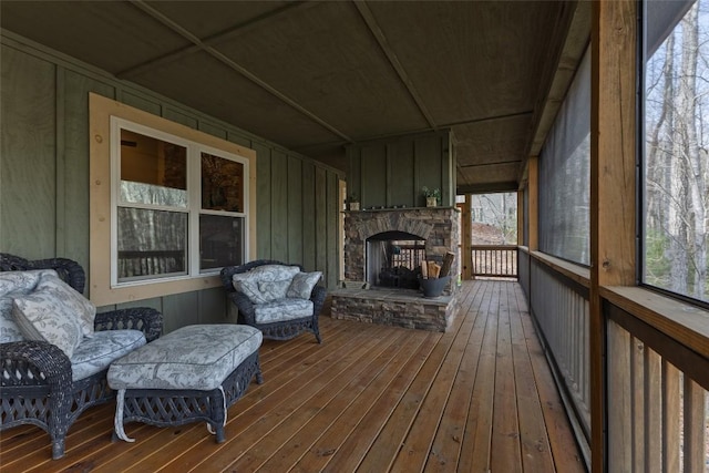 wooden deck featuring a stone fireplace