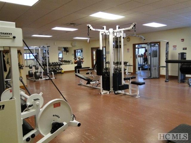 gym with a paneled ceiling