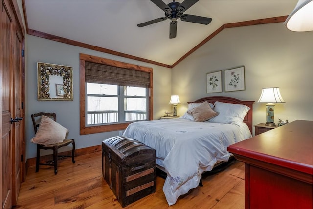 bedroom featuring lofted ceiling, ceiling fan, baseboards, light wood finished floors, and crown molding