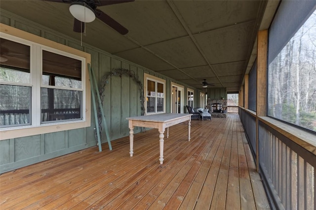 deck featuring covered porch and a ceiling fan