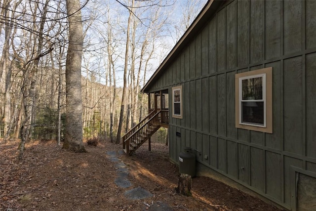 view of side of home featuring stairway and board and batten siding