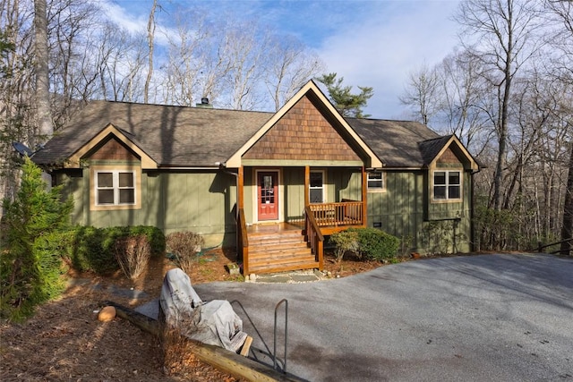 view of front facade with a porch and a shingled roof