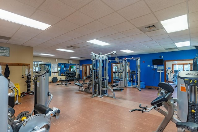 gym with a paneled ceiling