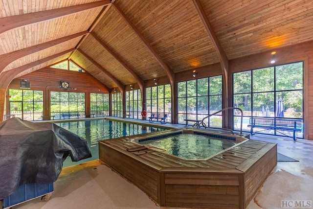 view of swimming pool featuring a grill and an indoor in ground hot tub