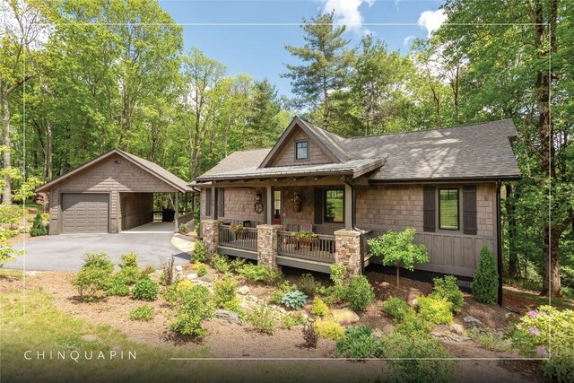 194 Redrock Trl, Glenville, NC 28736 - view of front of property featuring an outbuilding, a shingled roof, stone siding, and a garage