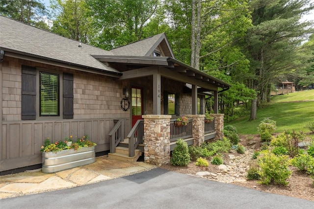 194 Redrock Trl, Glenville, NC 28736 - exterior space with board and batten siding, a shingled roof, covered porch, and a front yard