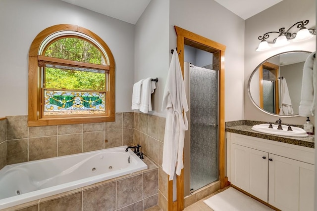 bathroom featuring a shower stall, vanity, and a whirlpool tub
