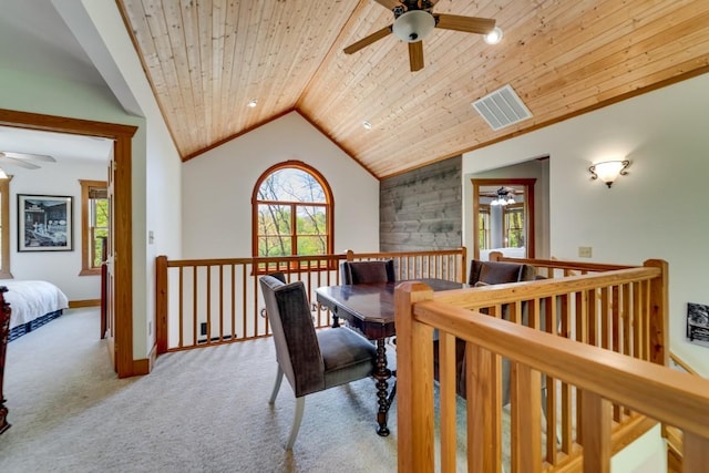 carpeted office with a ceiling fan, healthy amount of natural light, vaulted ceiling, wooden ceiling, and baseboards