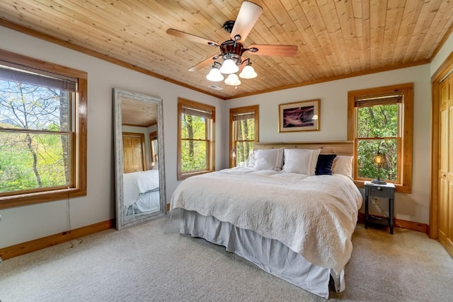 bedroom featuring crown molding, light colored carpet, baseboards, wood ceiling, and a ceiling fan