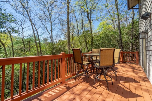 wooden deck featuring outdoor dining area