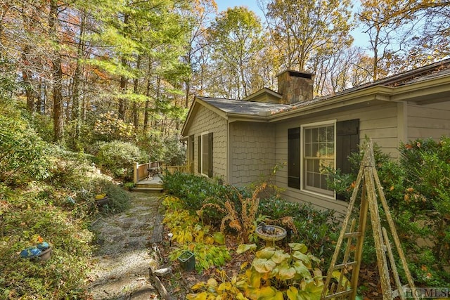 view of side of property with a wooden deck