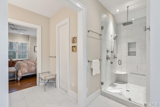 bathroom featuring a shower with door, tile patterned floors, and ceiling fan