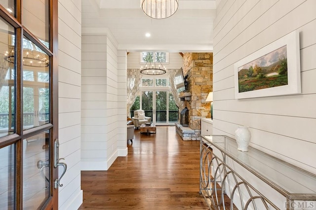 corridor featuring a notable chandelier and dark hardwood / wood-style flooring