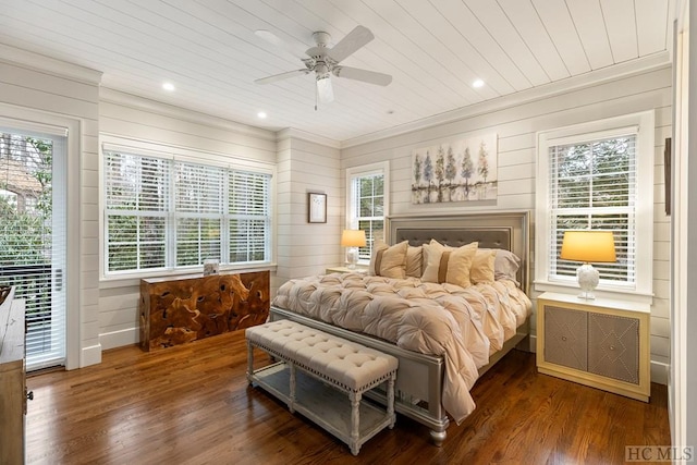 bedroom featuring dark hardwood / wood-style floors, ceiling fan, access to exterior, and multiple windows