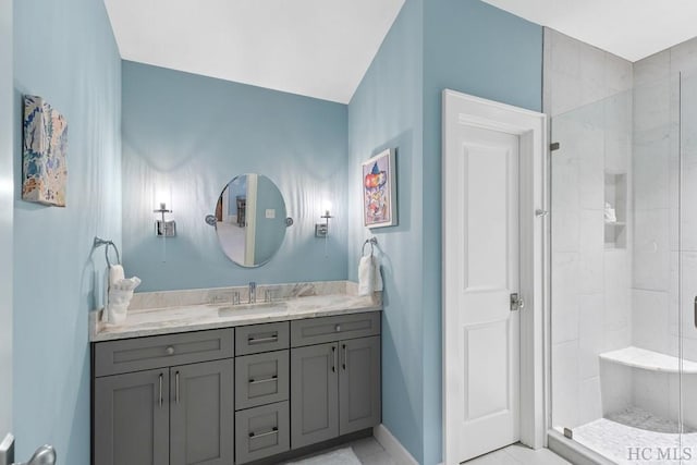 bathroom with vanity and a shower with door