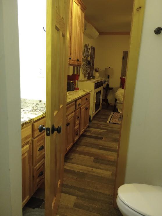 interior space featuring crown molding, light stone countertops, and dark hardwood / wood-style flooring