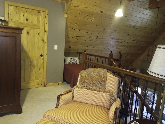 living area with wooden walls, light carpet, and wooden ceiling