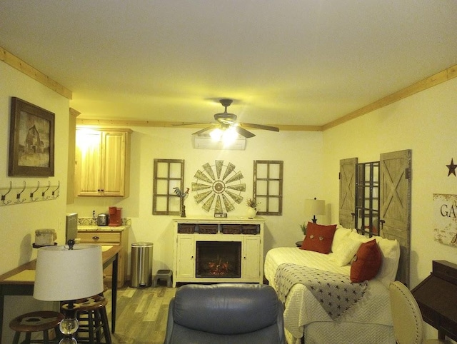 living room with ornamental molding, ceiling fan, and light hardwood / wood-style flooring