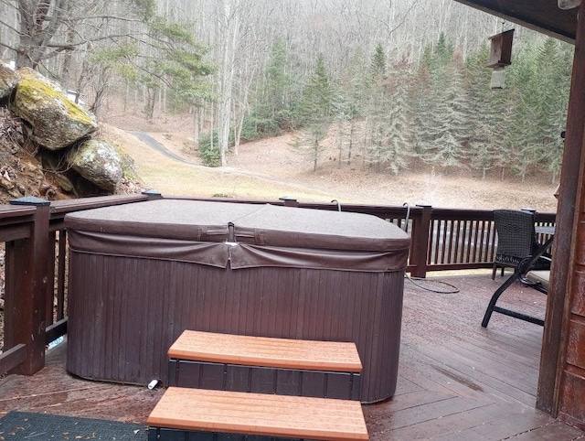 wooden terrace featuring a hot tub