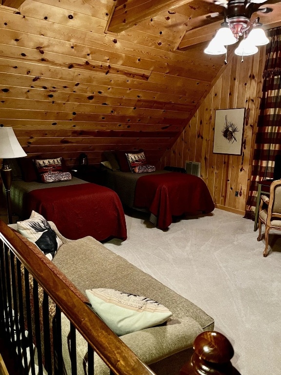 carpeted bedroom featuring vaulted ceiling, ceiling fan, and wood walls