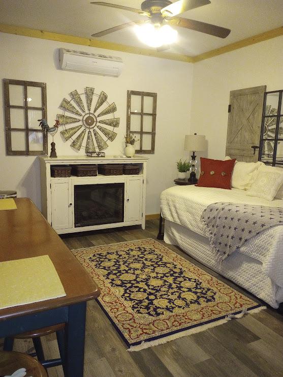 bedroom featuring ceiling fan, ornamental molding, dark hardwood / wood-style floors, and a wall mounted AC