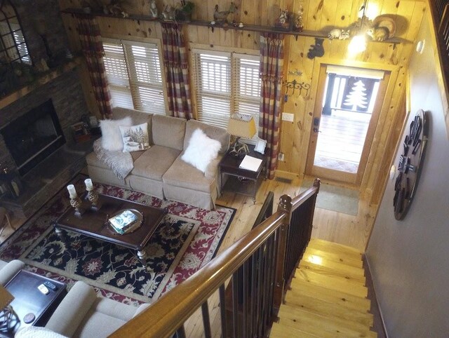 living room featuring hardwood / wood-style floors and wood walls