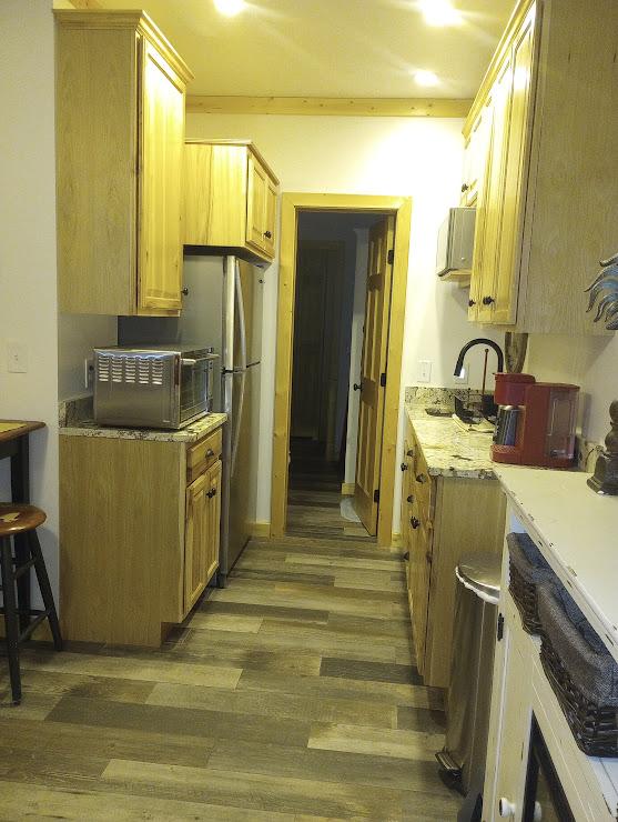 kitchen with sink, hardwood / wood-style flooring, stainless steel refrigerator, and light brown cabinets