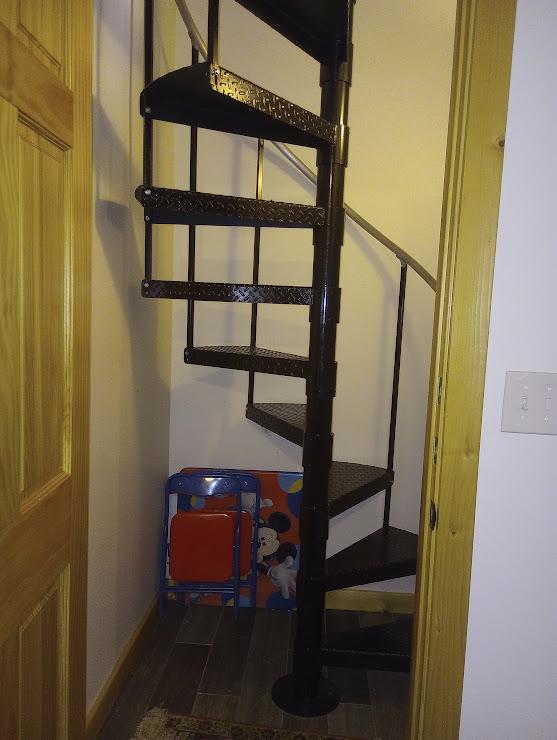 stairway with hardwood / wood-style floors