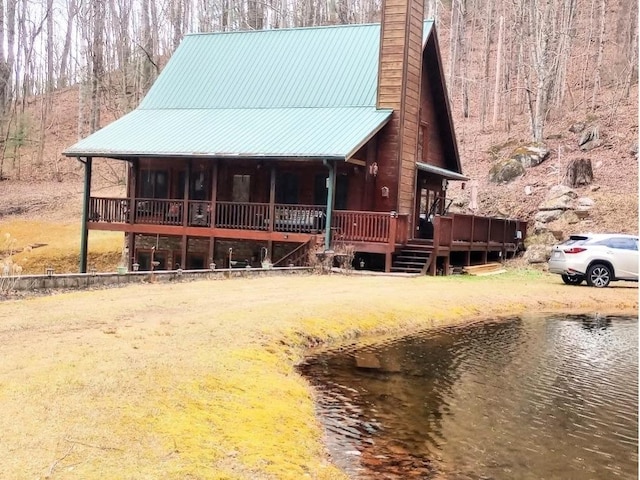 view of front of home with a deck with water view