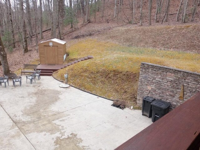 view of yard with an outdoor fire pit, a patio, and a shed