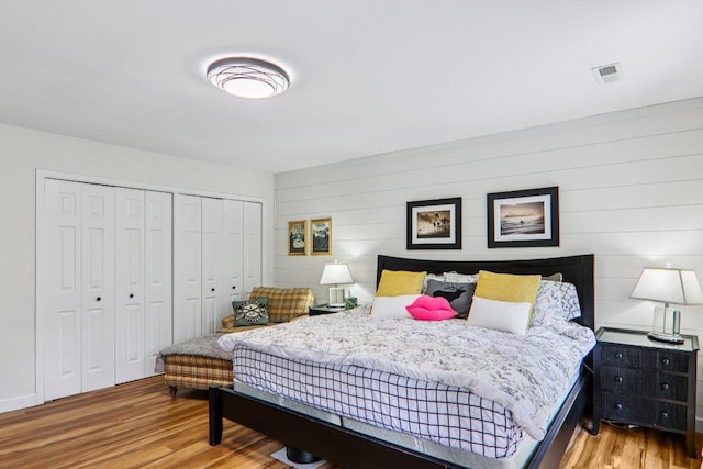 98 Dogwood Knob Ln Unit 3A, Sapphire, NC 28774 - bedroom featuring wood finished floors, a closet, and wood walls