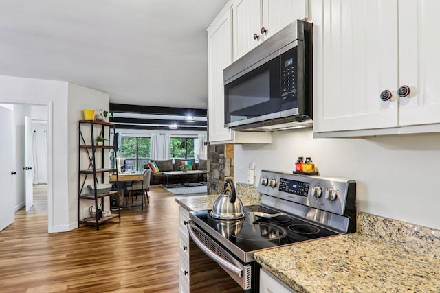 98 Dogwood Knob Ln Unit 3A, Sapphire, NC 28774 - kitchen with appliances with stainless steel finishes, white cabinetry, wood finished floors, light stone countertops, and open floor plan