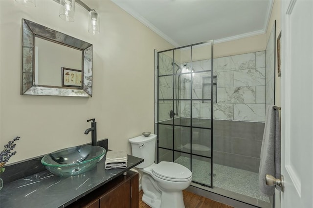 full bath featuring toilet, ornamental molding, a tile shower, wood finished floors, and vanity