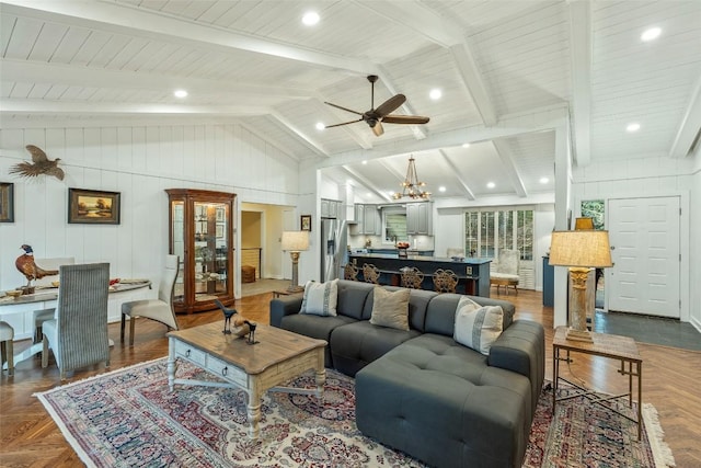 living room with ceiling fan with notable chandelier and vaulted ceiling with beams