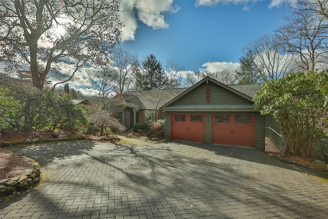 view of front of home featuring decorative driveway and an attached garage