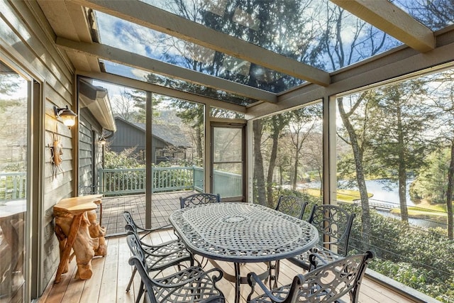 sunroom / solarium with a water view