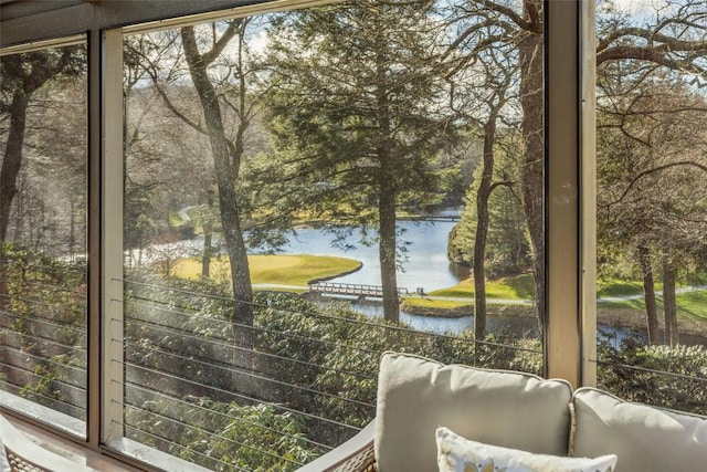 doorway to outside featuring a healthy amount of sunlight and a water view