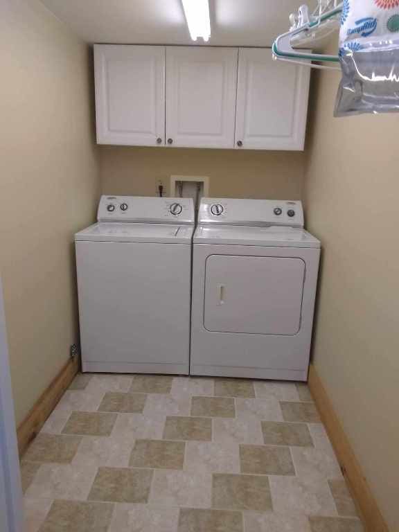 172 Moon Ridge Dr, Sky Valley, GA 30537 - washroom featuring washing machine and dryer, cabinet space, and baseboards