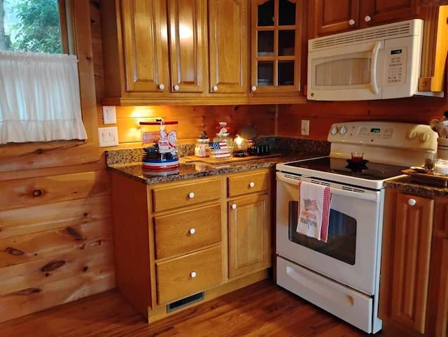 172 Moon Ridge Dr, Sky Valley, GA 30537 - kitchen with white appliances, wood finished floors, glass insert cabinets, brown cabinetry, and dark stone countertops