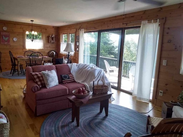 172 Moon Ridge Dr, Sky Valley, GA 30537 - living room featuring wooden walls, light wood-style floors, and a chandelier