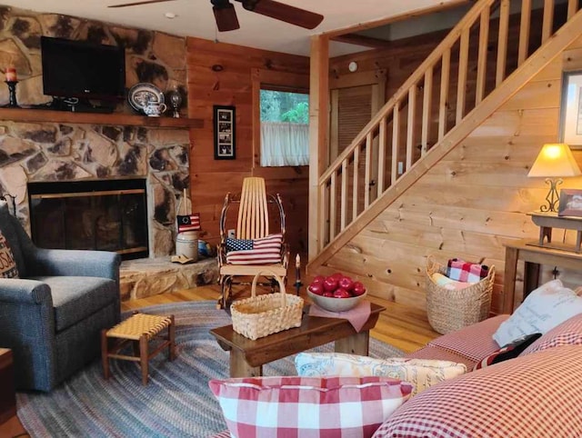 172 Moon Ridge Dr, Sky Valley, GA 30537 - living room featuring a ceiling fan, wood finished floors, wooden walls, stairway, and a fireplace