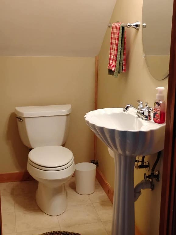 172 Moon Ridge Dr, Sky Valley, GA 30537 - half bath featuring tile patterned floors, baseboards, toilet, and vaulted ceiling