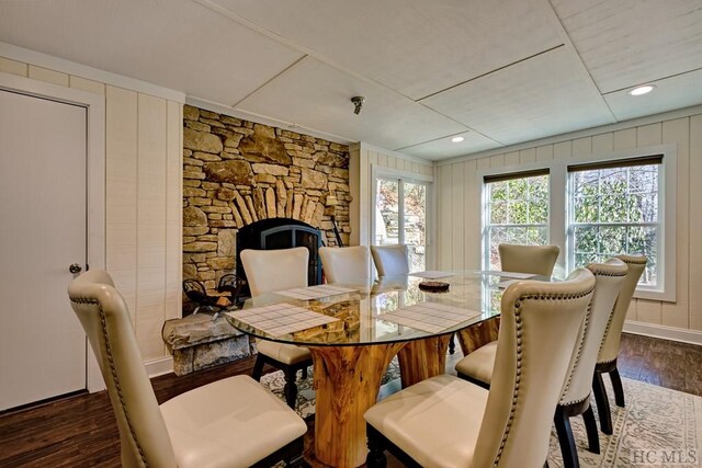 dining space featuring dark wood-type flooring and a fireplace