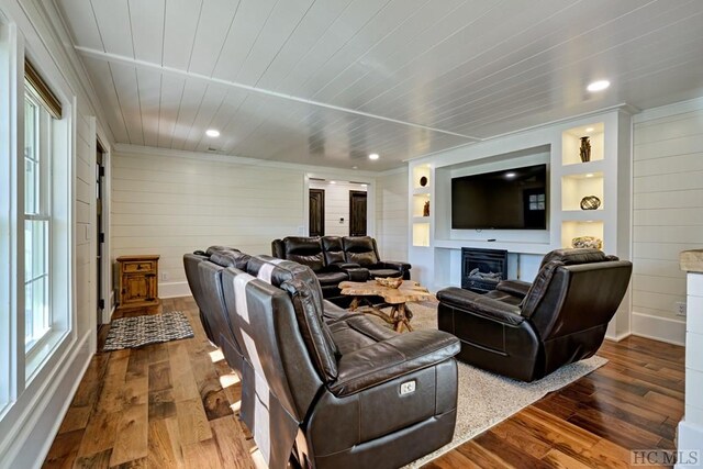 living room with wood ceiling, wood-type flooring, and wooden walls