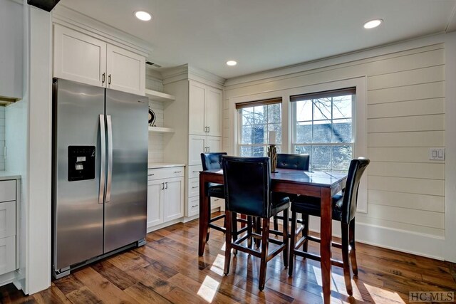 dining space with dark hardwood / wood-style flooring