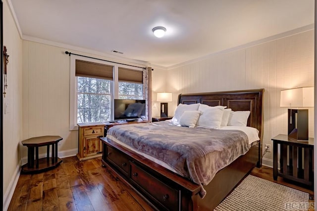 bedroom with crown molding and dark hardwood / wood-style floors