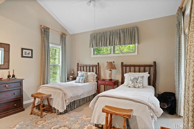 carpeted bedroom with ceiling fan and lofted ceiling