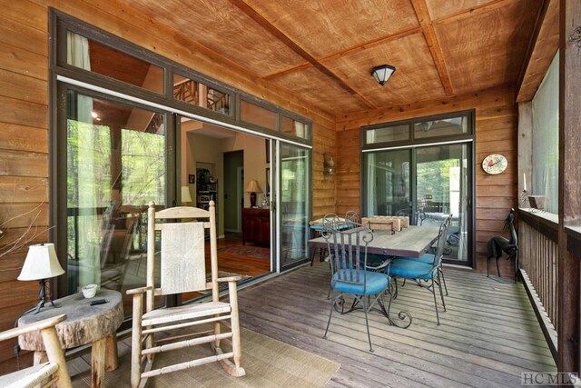 sunroom featuring wooden ceiling and a healthy amount of sunlight