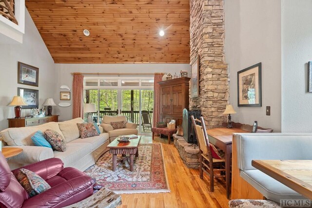 living room with light hardwood / wood-style flooring, high vaulted ceiling, and wood ceiling